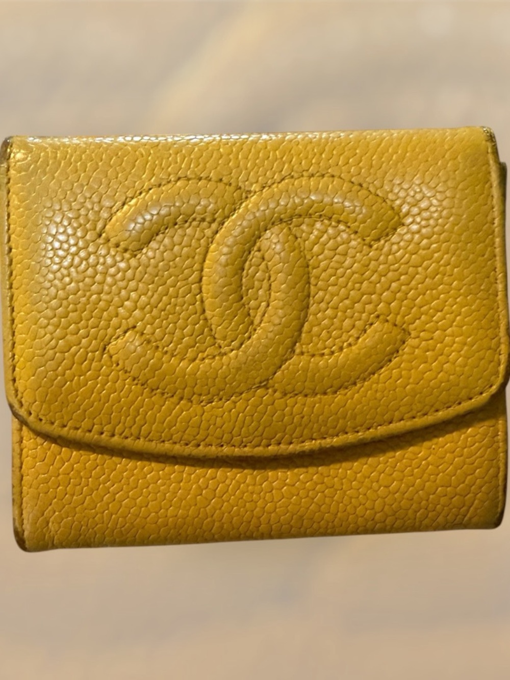 Chanel yellow caviar-leather wallets with an embossed CC logo
